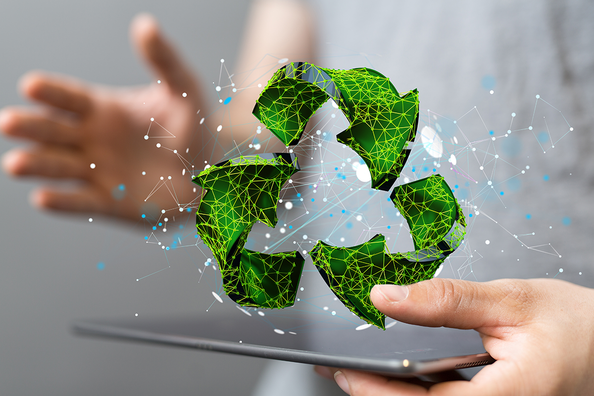 Digital recycling symbol above a tablet, representing eco-friendly technology innovation.